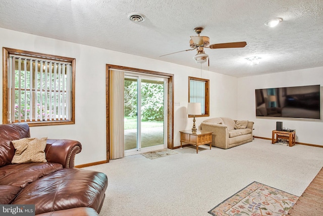 1021 Carson Dr, Huntingtown, MD 20639 - carpeted living room featuring a ceiling fan and a textured ceiling