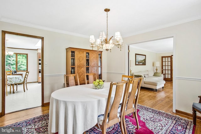 1021 Carson Dr, Huntingtown, MD 20639 - dining area with a chandelier, light wood finished floors, and crown molding