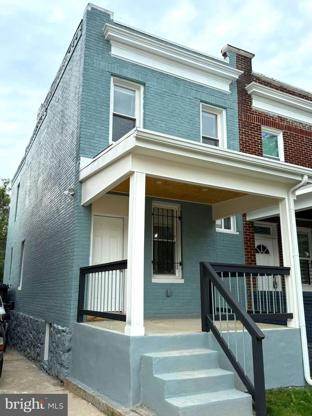 2717 Wilkens Ave, Baltimore, MD 21223 - view of front facade with brick siding and a porch