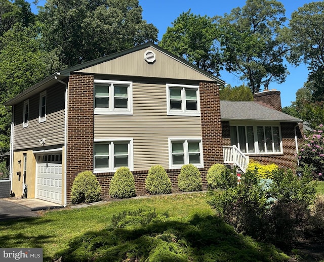 194 Irene Ave, Pasadena, MD 21122 - view of front of property featuring a garage, brick siding, and a front yard