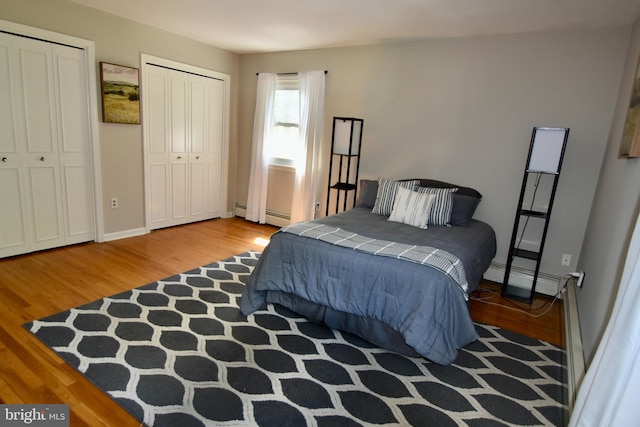 194 Irene Ave, Pasadena, MD 21122 - bedroom with wood finished floors, a baseboard radiator, and multiple closets