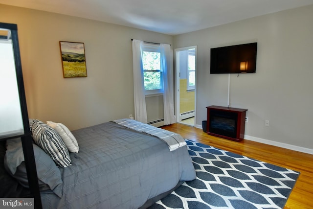 194 Irene Ave, Pasadena, MD 21122 - bedroom with wood finished floors, baseboards, and a baseboard radiator