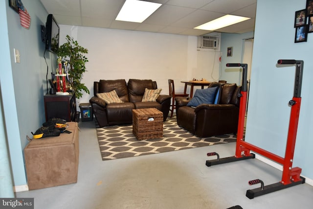 194 Irene Ave, Pasadena, MD 21122 - living room with a drop ceiling, finished concrete floors, and a wall mounted air conditioner