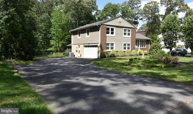 194 Irene Ave, Pasadena, MD 21122 - view of front of house featuring driveway, a garage, a chimney, and cooling unit