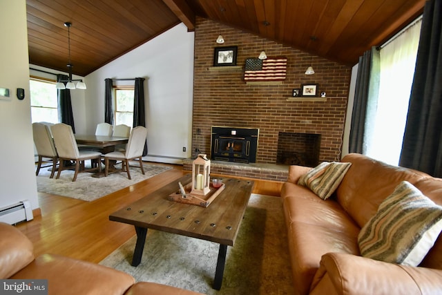 194 Irene Ave, Pasadena, MD 21122 - living area featuring a brick fireplace, vaulted ceiling, wood finished floors, a baseboard heating unit, and brick wall