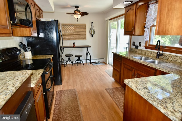 194 Irene Ave, Pasadena, MD 21122 - kitchen featuring black appliances, a sink, baseboard heating, light wood-style flooring, and ceiling fan