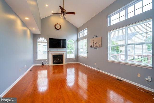 4 Bernadette Cir, Monmouth Junction, NJ 08852 - unfurnished living room with a ceiling fan, plenty of natural light, a fireplace with flush hearth, high vaulted ceiling, and wood-type flooring
