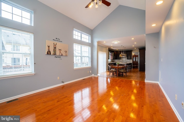 4 Bernadette Cir, Monmouth Junction, NJ 08852 - unfurnished living room featuring high vaulted ceiling, a ceiling fan, light wood-style floors, baseboards, and recessed lighting