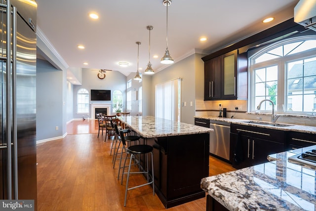 4 Bernadette Cir, Monmouth Junction, NJ 08852 - kitchen with stainless steel appliances, a sink, open floor plan, a center island, and light stone countertops