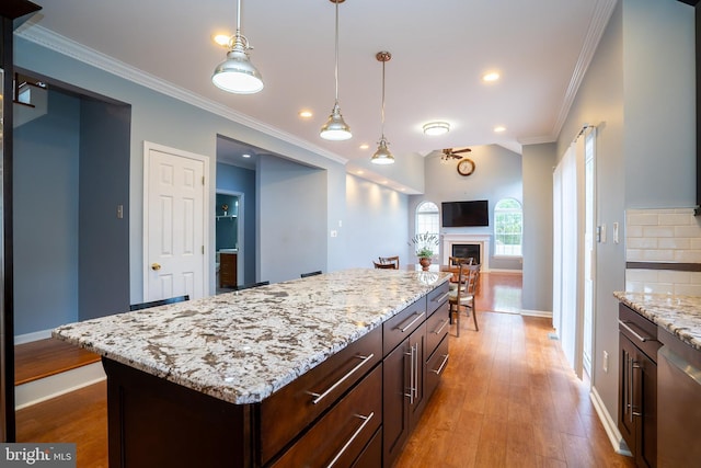 4 Bernadette Cir, Monmouth Junction, NJ 08852 - kitchen featuring ornamental molding, baseboards, light wood finished floors, decorative light fixtures, and dark brown cabinetry