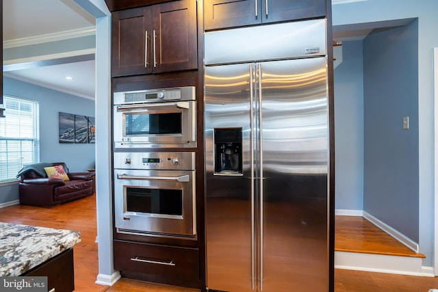 4 Bernadette Cir, Monmouth Junction, NJ 08852 - kitchen featuring stainless steel appliances, crown molding, dark brown cabinetry, wood finished floors, and baseboards