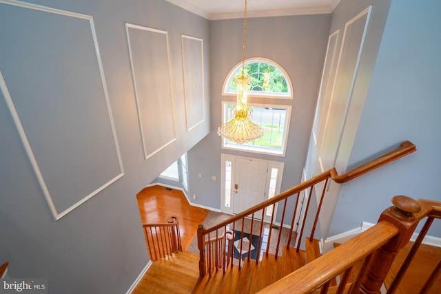 4 Bernadette Cir, Monmouth Junction, NJ 08852 - stairway featuring wood finished floors, a chandelier, baseboards, crown molding, and a towering ceiling
