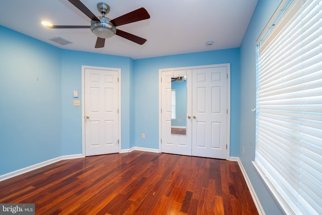 4 Bernadette Cir, Monmouth Junction, NJ 08852 - unfurnished bedroom with dark wood-style floors, baseboards, a ceiling fan, and a closet