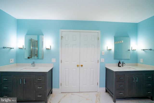 4 Bernadette Cir, Monmouth Junction, NJ 08852 - bathroom featuring marble finish flooring, two vanities, a towel warmer, and baseboards