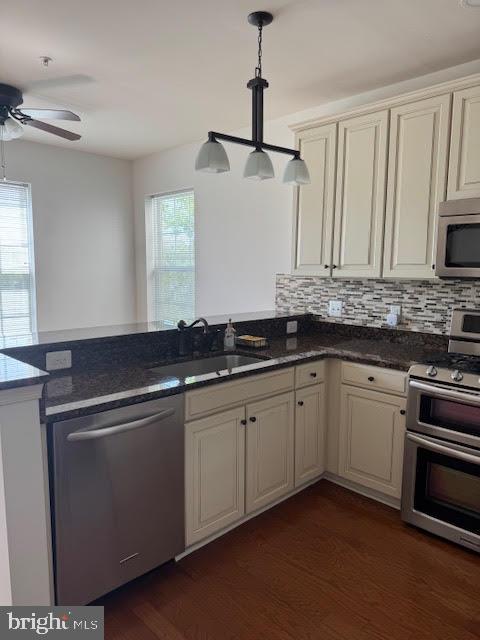 9200 Charleston Dr Unit 207, Manassas, VA 20110 - kitchen with appliances with stainless steel finishes, a sink, a peninsula, ceiling fan, and dark wood-style floors