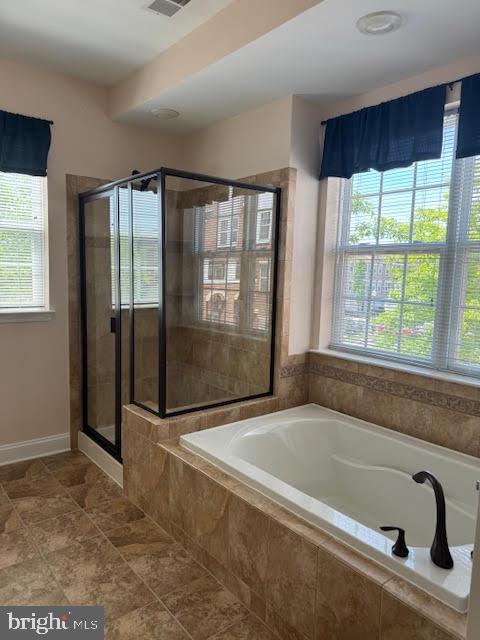 9200 Charleston Dr Unit 207, Manassas, VA 20110 - bathroom featuring healthy amount of natural light, a stall shower, a bath, and tile patterned floors
