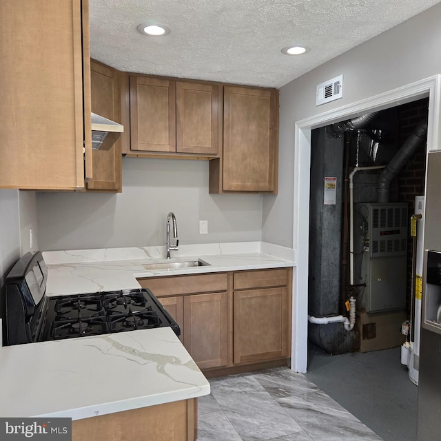 9711 Dilston Rd, Silver Spring, MD 20903 - kitchen with a sink, stainless steel gas stove, a textured ceiling, brown cabinets, and light stone countertops