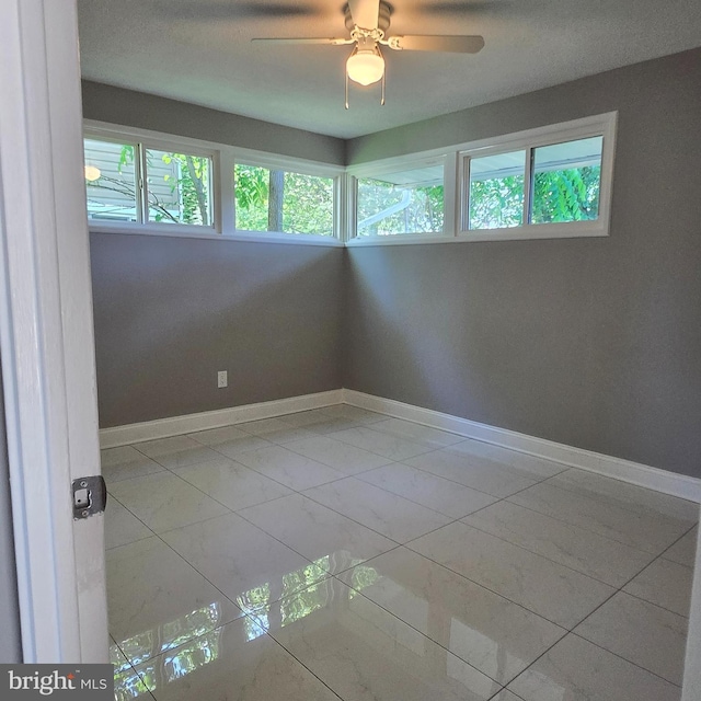 9711 Dilston Rd, Silver Spring, MD 20903 - unfurnished room featuring plenty of natural light, a ceiling fan, and baseboards