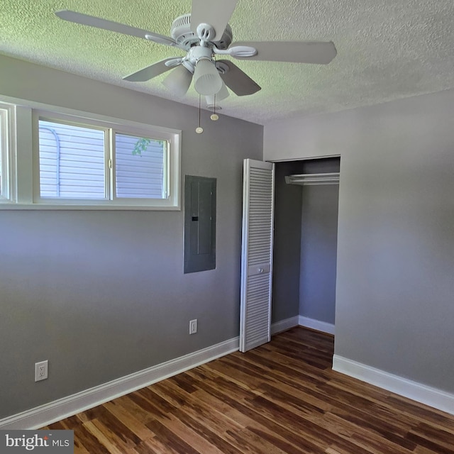 9711 Dilston Rd, Silver Spring, MD 20903 - unfurnished bedroom with electric panel, wood finished floors, a closet, baseboards, and a textured ceiling
