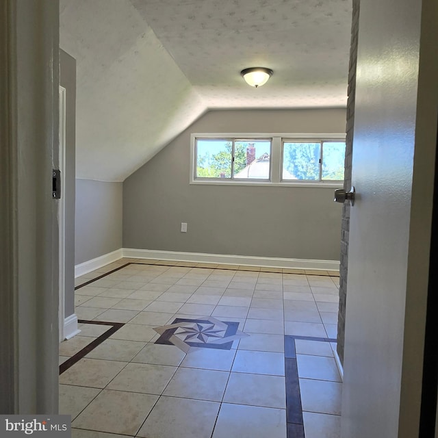 9711 Dilston Rd, Silver Spring, MD 20903 - bonus room featuring lofted ceiling, baseboards, and light tile patterned floors