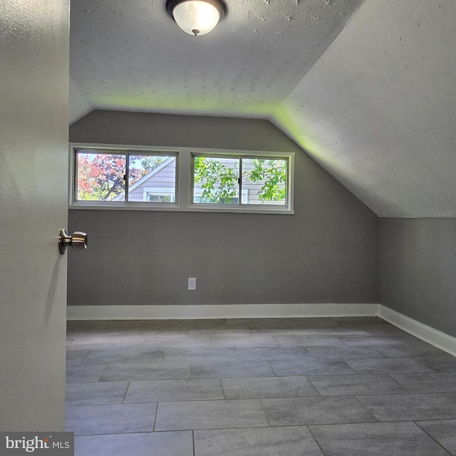 9711 Dilston Rd, Silver Spring, MD 20903 - additional living space featuring vaulted ceiling, baseboards, and a textured ceiling