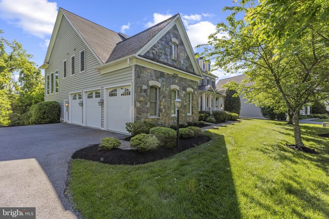 17621 Auburn Village Dr, Sandy Spring, MD 20860 - view of property exterior featuring stone siding, asphalt driveway, a yard, a garage, and a shingled roof