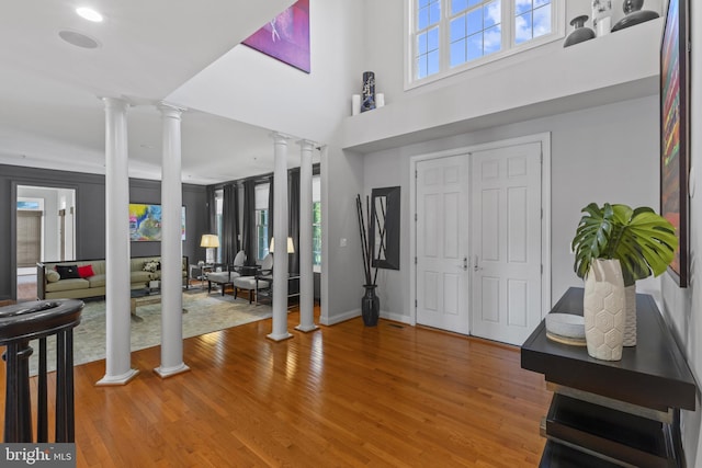 17621 Auburn Village Dr, Sandy Spring, MD 20860 - entryway featuring decorative columns, plenty of natural light, wood finished floors, and a high ceiling