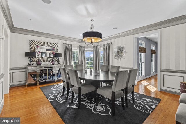 17621 Auburn Village Dr, Sandy Spring, MD 20860 - dining space with a chandelier, crown molding, and light wood-style flooring