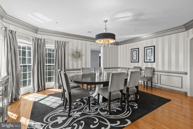 17621 Auburn Village Dr, Sandy Spring, MD 20860 - dining space with a chandelier, ornamental molding, wood finished floors, wallpapered walls, and wainscoting