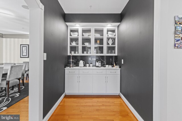 17621 Auburn Village Dr, Sandy Spring, MD 20860 - indoor wet bar with light wood-type flooring and baseboards