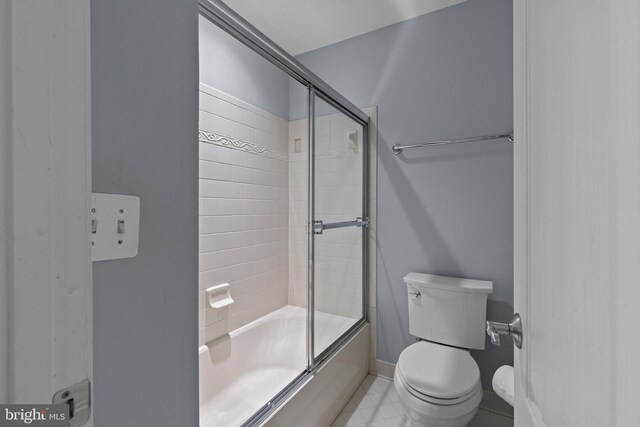 17621 Auburn Village Dr, Sandy Spring, MD 20860 - bathroom featuring toilet, enclosed tub / shower combo, baseboards, and tile patterned floors