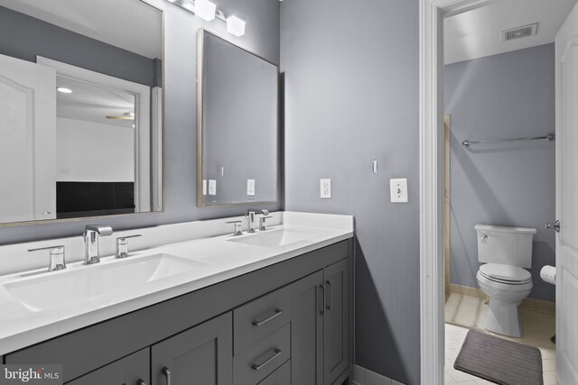 17621 Auburn Village Dr, Sandy Spring, MD 20860 - full bath featuring toilet, double vanity, tile patterned flooring, and baseboards