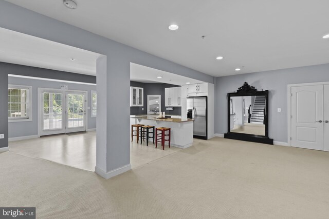 17621 Auburn Village Dr, Sandy Spring, MD 20860 - kitchen featuring stainless steel fridge, a kitchen breakfast bar, light carpet, white cabinetry, and recessed lighting