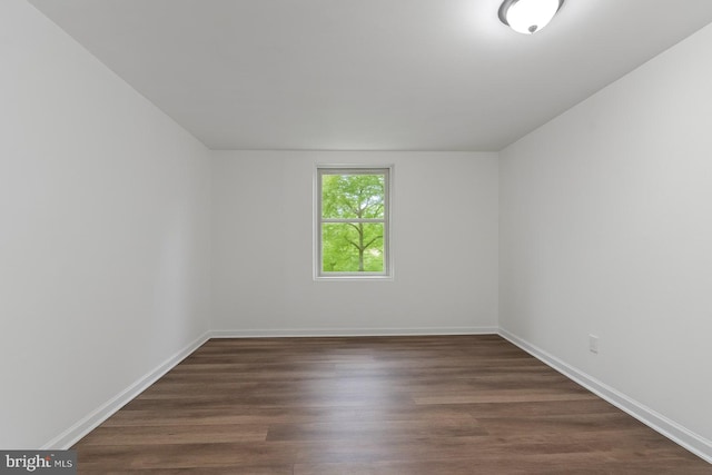 5911 Cecil Ave, Baltimore, MD 21207 - empty room featuring dark wood-style floors and baseboards
