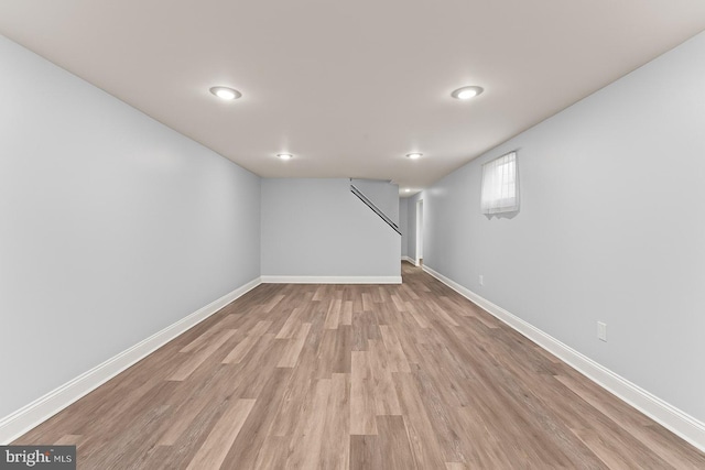 5911 Cecil Ave, Baltimore, MD 21207 - basement with light wood-style flooring, baseboards, and stairs