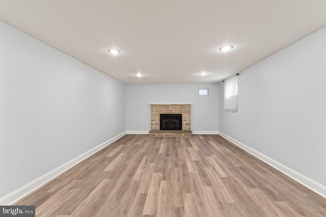 5911 Cecil Ave, Baltimore, MD 21207 - unfurnished living room with wood finished floors, baseboards, a stone fireplace, and recessed lighting
