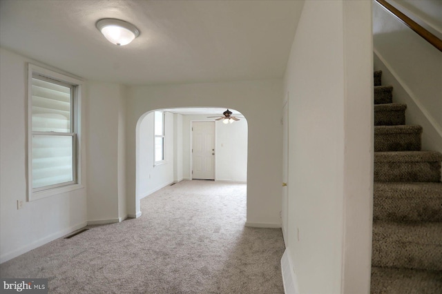 21 E Allen St, Mechanicsburg, PA 17055 - carpeted empty room with arched walkways, stairs, a ceiling fan, and baseboards