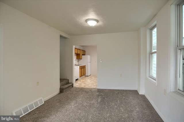 21 E Allen St, Mechanicsburg, PA 17055 - spare room featuring light colored carpet, stairs, and baseboards