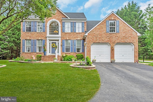 8139 Showcase Ct, Pasadena, MD 21122 - colonial home with asphalt driveway, a front yard, brick siding, and an attached garage