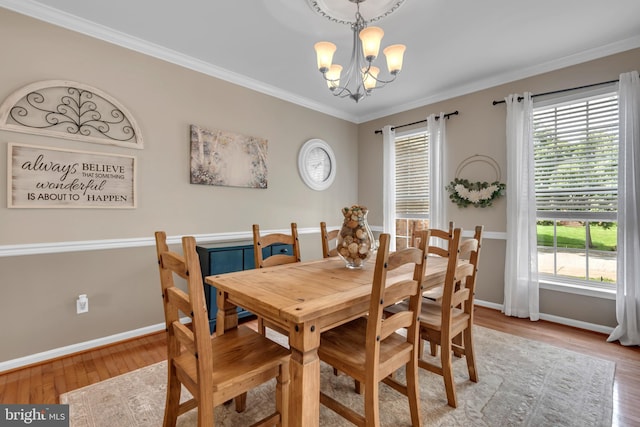 8139 Showcase Ct, Pasadena, MD 21122 - dining area featuring a chandelier, baseboards, wood finished floors, and ornamental molding