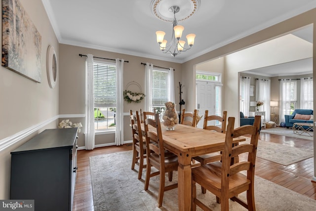 8139 Showcase Ct, Pasadena, MD 21122 - dining room featuring a chandelier, wood finished floors, crown molding, and baseboards