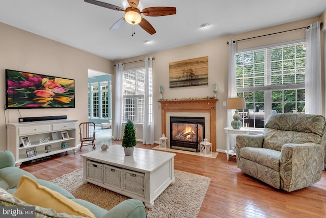 8139 Showcase Ct, Pasadena, MD 21122 - living room featuring a ceiling fan, a fireplace with flush hearth, healthy amount of natural light, light wood-style floors, and recessed lighting