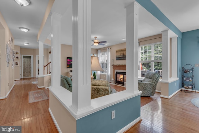 8139 Showcase Ct, Pasadena, MD 21122 - corridor featuring decorative columns, healthy amount of natural light, hardwood / wood-style flooring, and baseboards