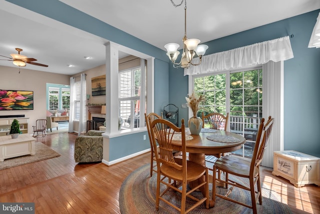 8139 Showcase Ct, Pasadena, MD 21122 - dining room featuring wood-type flooring, a chandelier, baseboards, and a ceiling fan