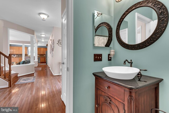 8139 Showcase Ct, Pasadena, MD 21122 - bathroom with hardwood / wood-style flooring, vanity, and baseboards