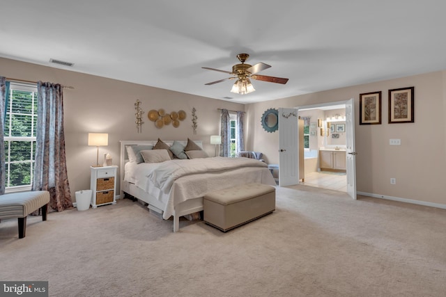 8139 Showcase Ct, Pasadena, MD 21122 - bedroom with light carpet, connected bathroom, baseboards, and a ceiling fan