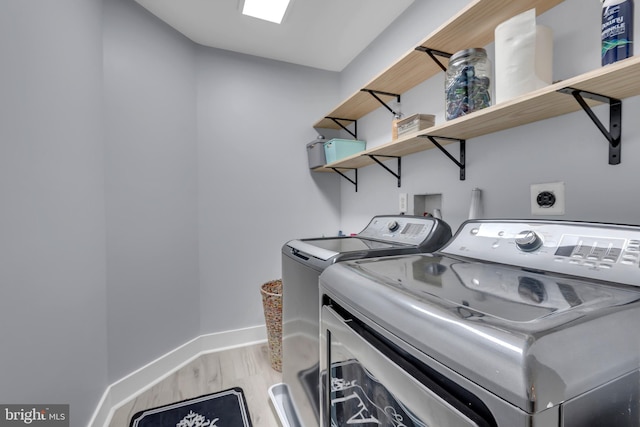 8139 Showcase Ct, Pasadena, MD 21122 - laundry room with washer and dryer, baseboards, and light wood-style floors