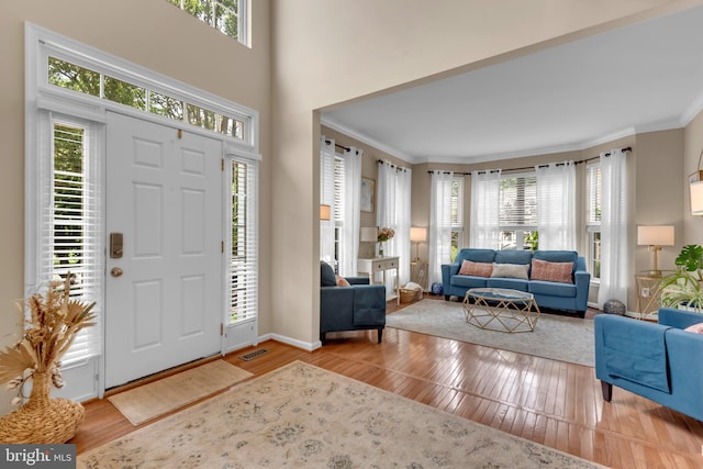 8139 Showcase Ct, Pasadena, MD 21122 - foyer entrance with hardwood / wood-style floors, crown molding, and baseboards