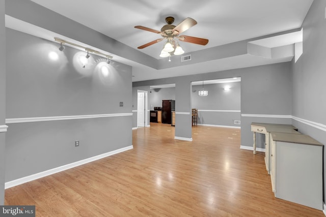 8139 Showcase Ct, Pasadena, MD 21122 - unfurnished room with a ceiling fan, light wood-style floors, baseboards, track lighting, and a raised ceiling