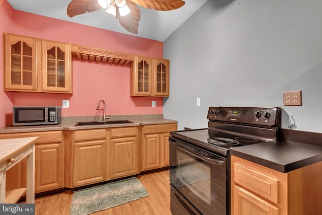 8139 Showcase Ct, Pasadena, MD 21122 - kitchen featuring black / electric stove, stainless steel microwave, a sink, and light wood-style flooring